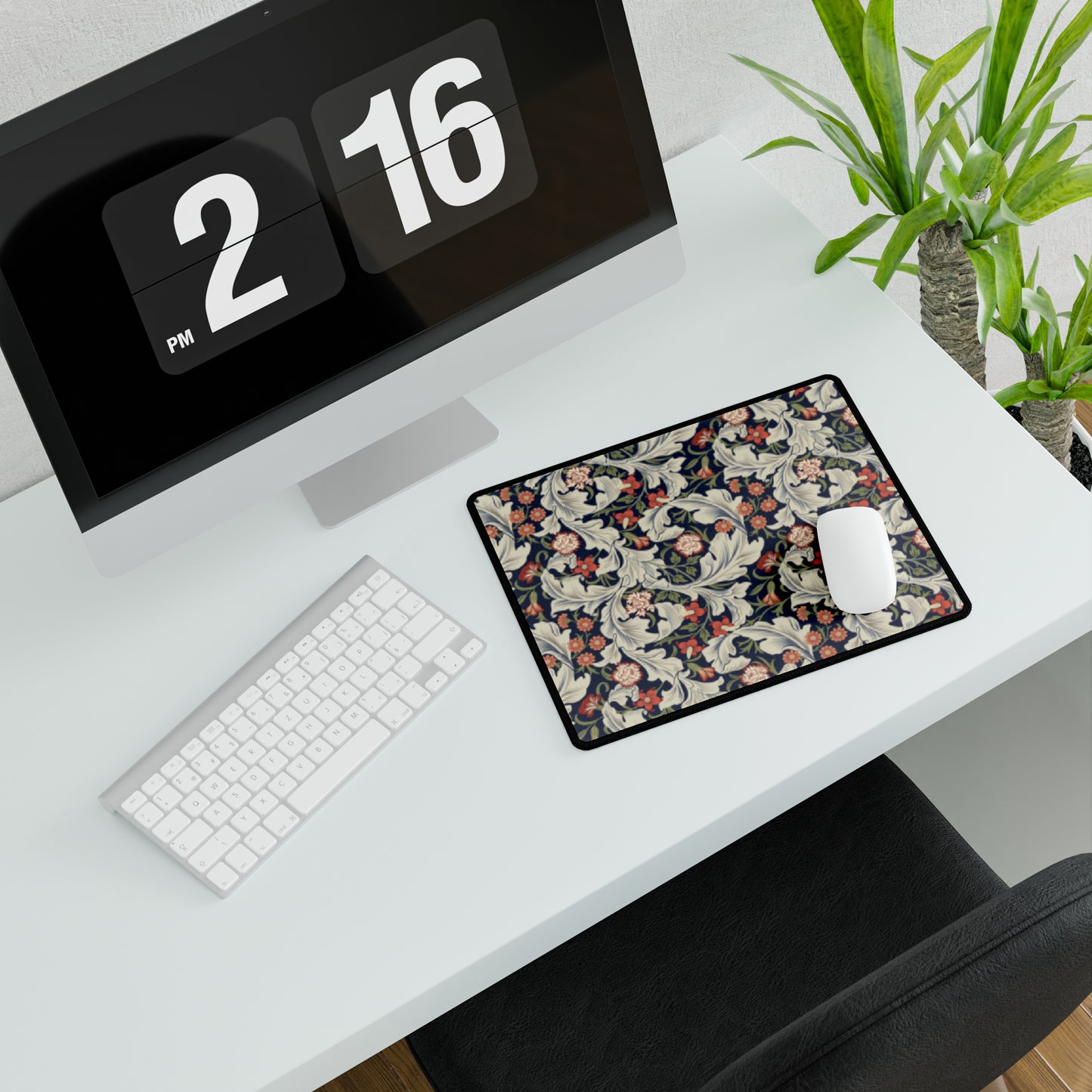 A large desk mat with a William Morris & Co floral pattern, inspired by William Morris, placed on a desk with a keyboard and mouse.