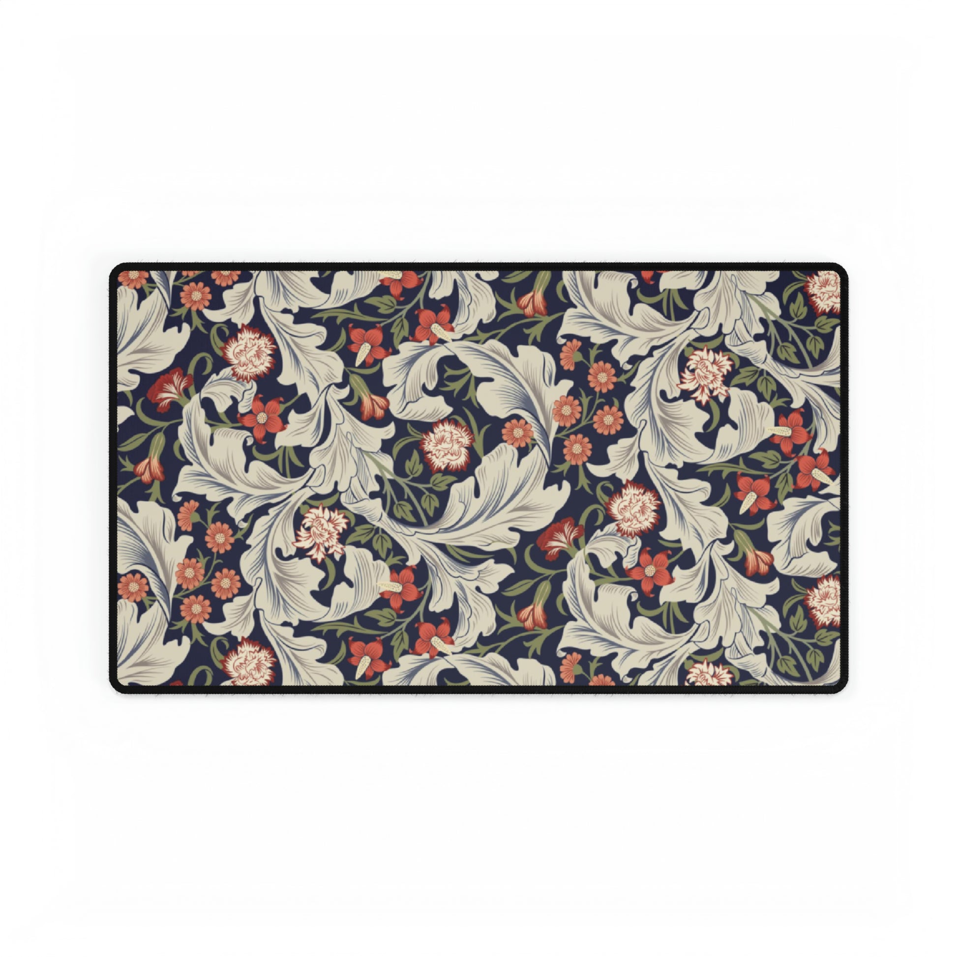 A large desk mat with a William Morris & Co floral pattern, inspired by William Morris, placed on a desk with a keyboard and mouse.