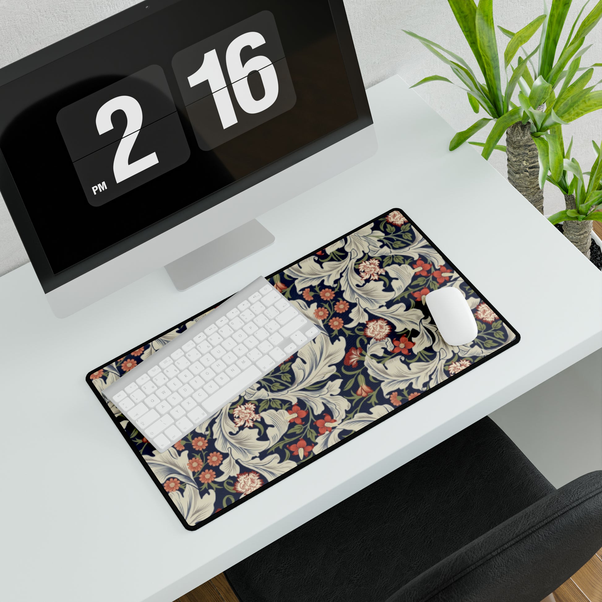 A large desk mat with a William Morris & Co floral pattern, inspired by William Morris, placed on a desk with a keyboard and mouse.