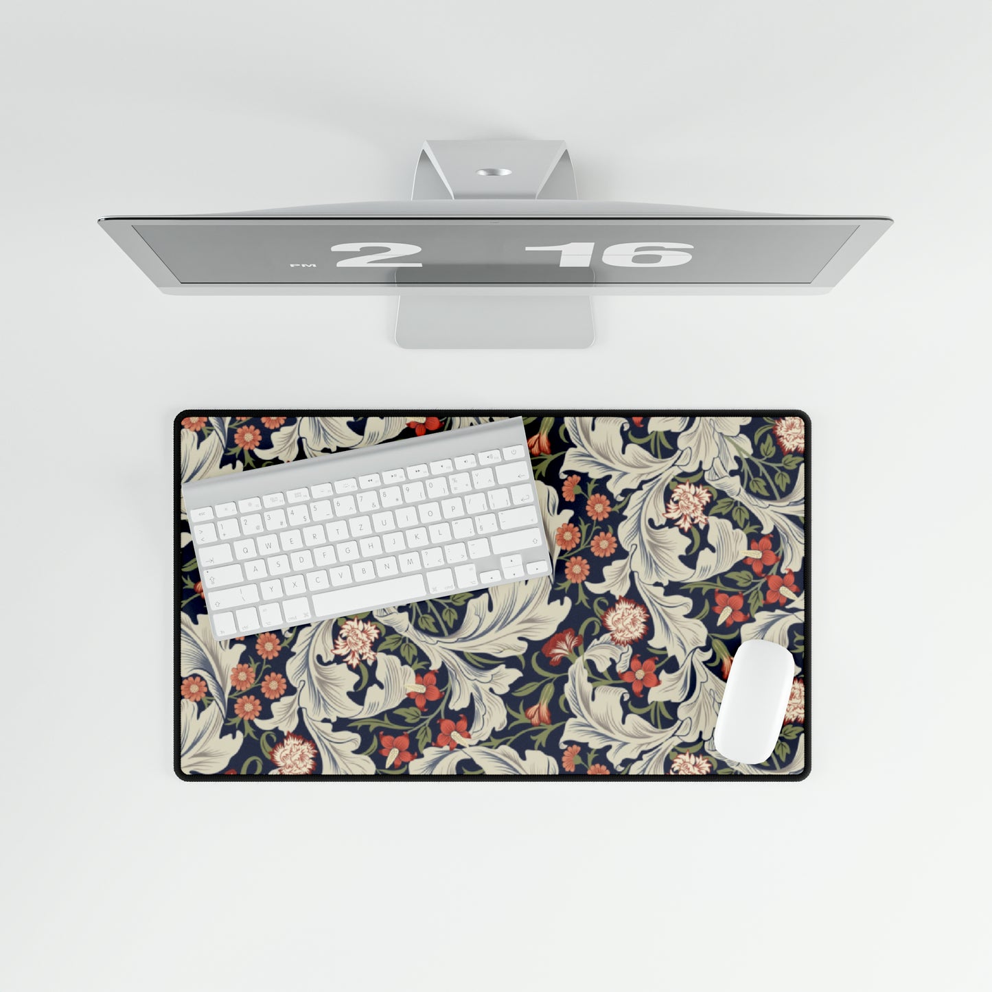 A large desk mat with a William Morris & Co floral pattern, inspired by William Morris, placed on a desk with a keyboard and mouse.