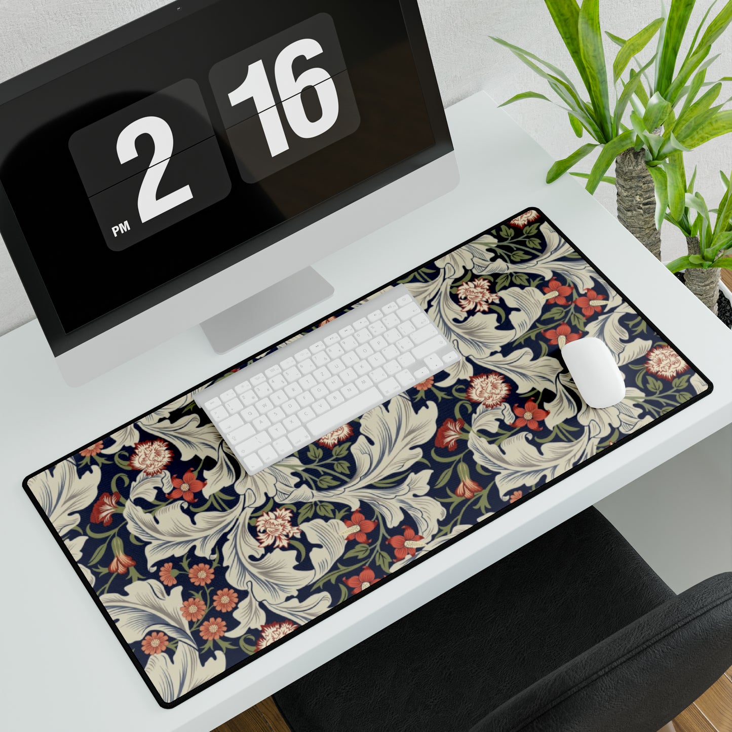 A large desk mat with a William Morris & Co floral pattern, inspired by William Morris, placed on a desk with a keyboard and mouse.