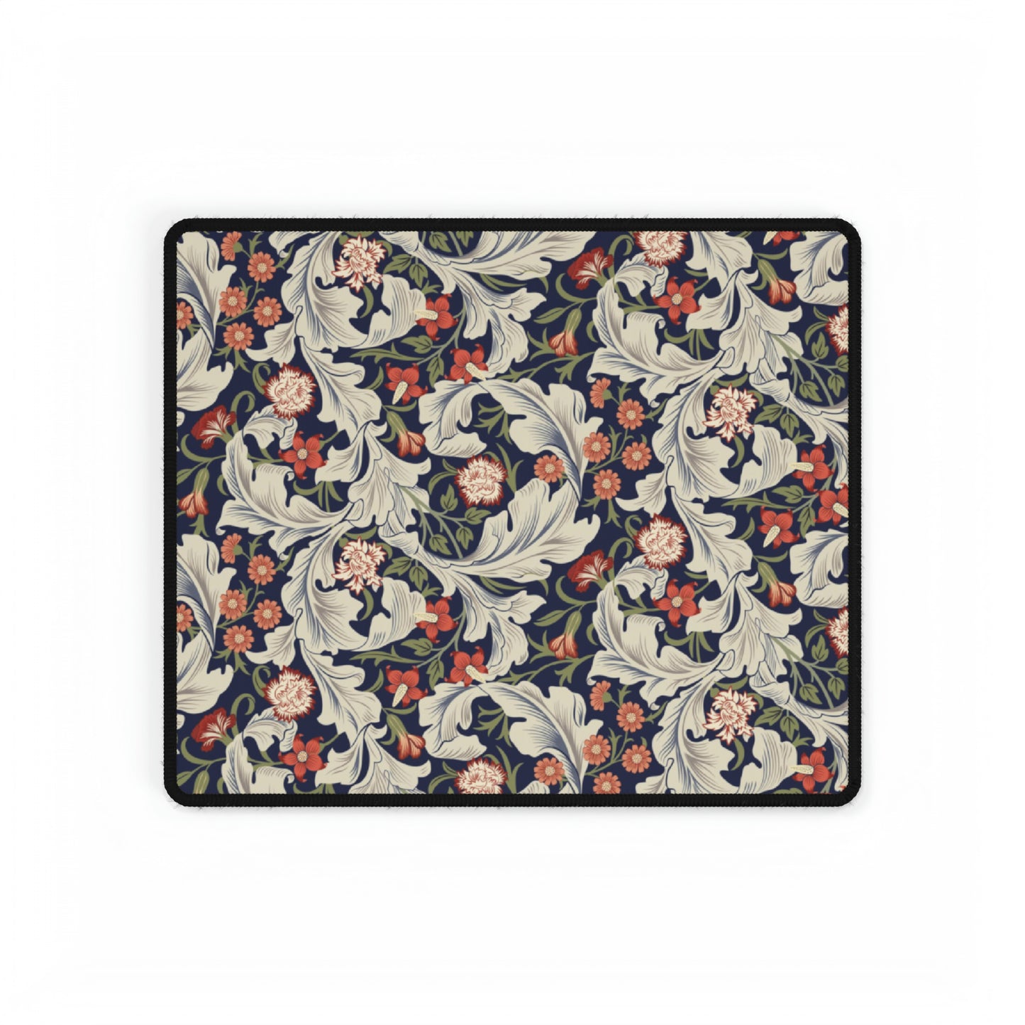 A large desk mat with a William Morris & Co floral pattern, inspired by William Morris, placed on a desk with a keyboard and mouse.