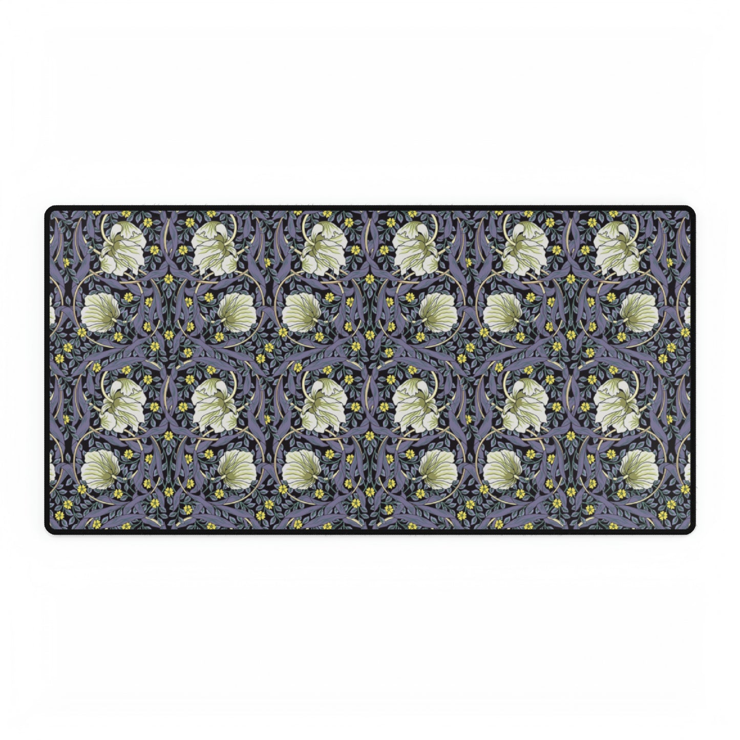 A large desk mat with a William Morris & Co floral pattern in shades of purple and green, displayed on a desk with a keyboard and mouse.
