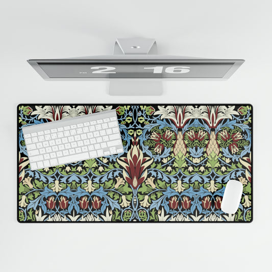A large, decorative desk mat with a floral and geometric William Morris & Co pattern, displayed on a desk with a keyboard and mouse.