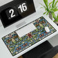 A large, decorative desk mat with a floral and geometric William Morris & Co pattern, displayed on a desk with a keyboard and mouse.