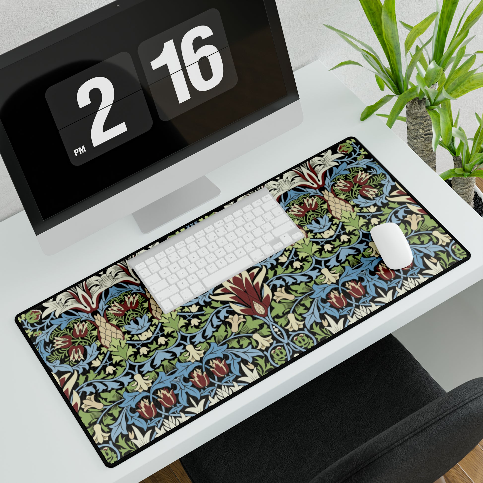 A large, decorative desk mat with a floral and geometric William Morris & Co pattern, displayed on a desk with a keyboard and mouse.