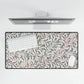 Floral patterned desk mat with a computer setup on a white background