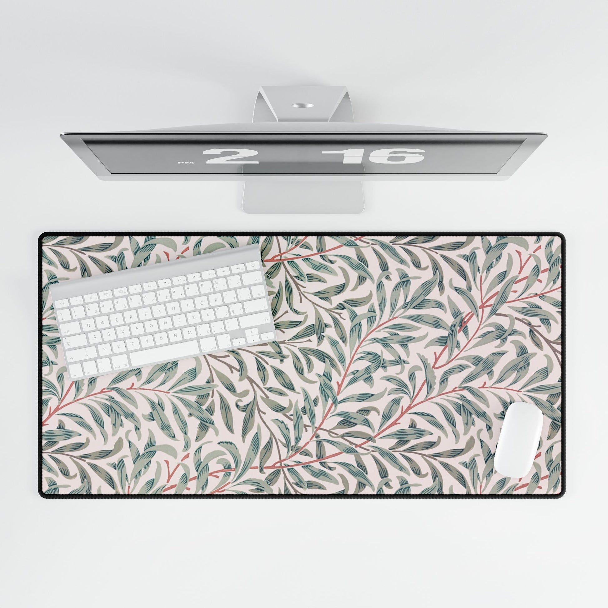 Floral patterned desk mat with a computer setup on a white background
