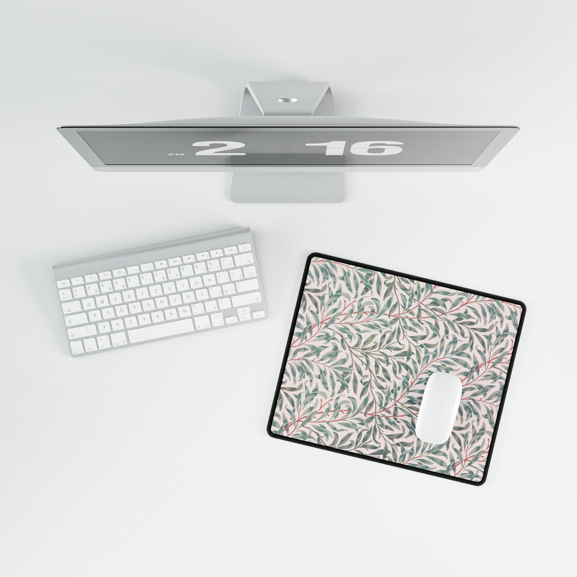 Floral mouse pad on a desk with a computer setup