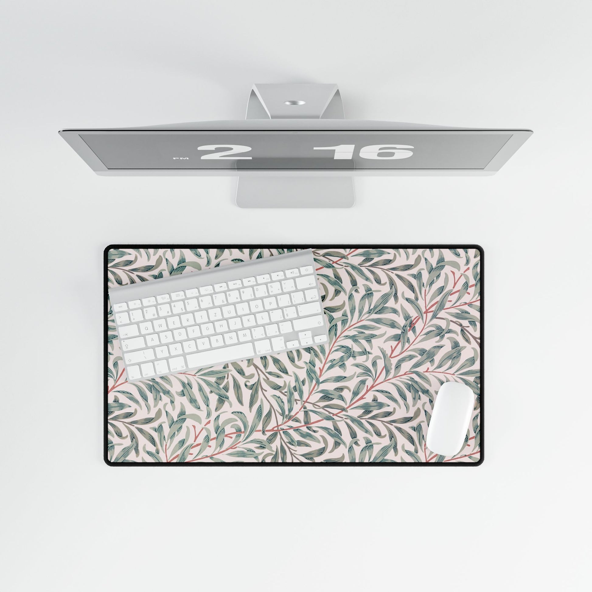 Floral desk mat with a computer setup on a white background