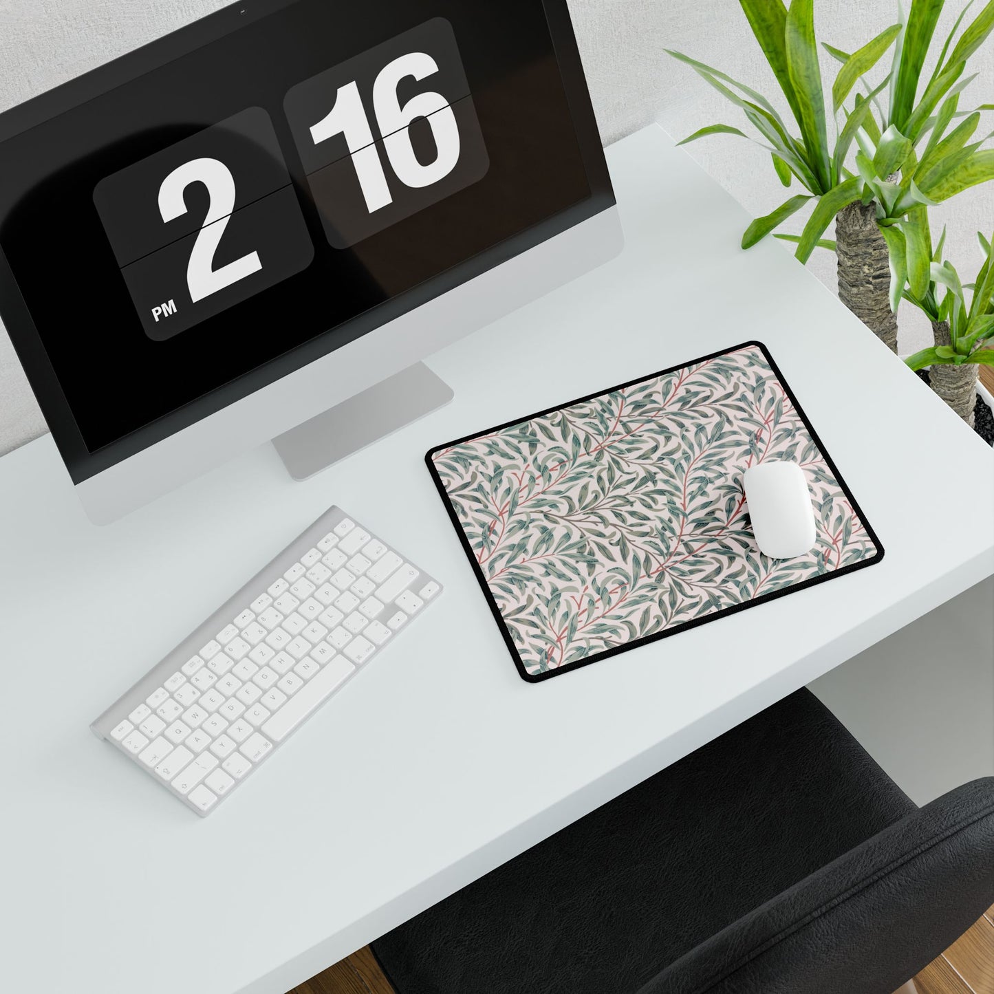 Desk setup with a computer, keyboard, mouse, and decorative mouse pad.