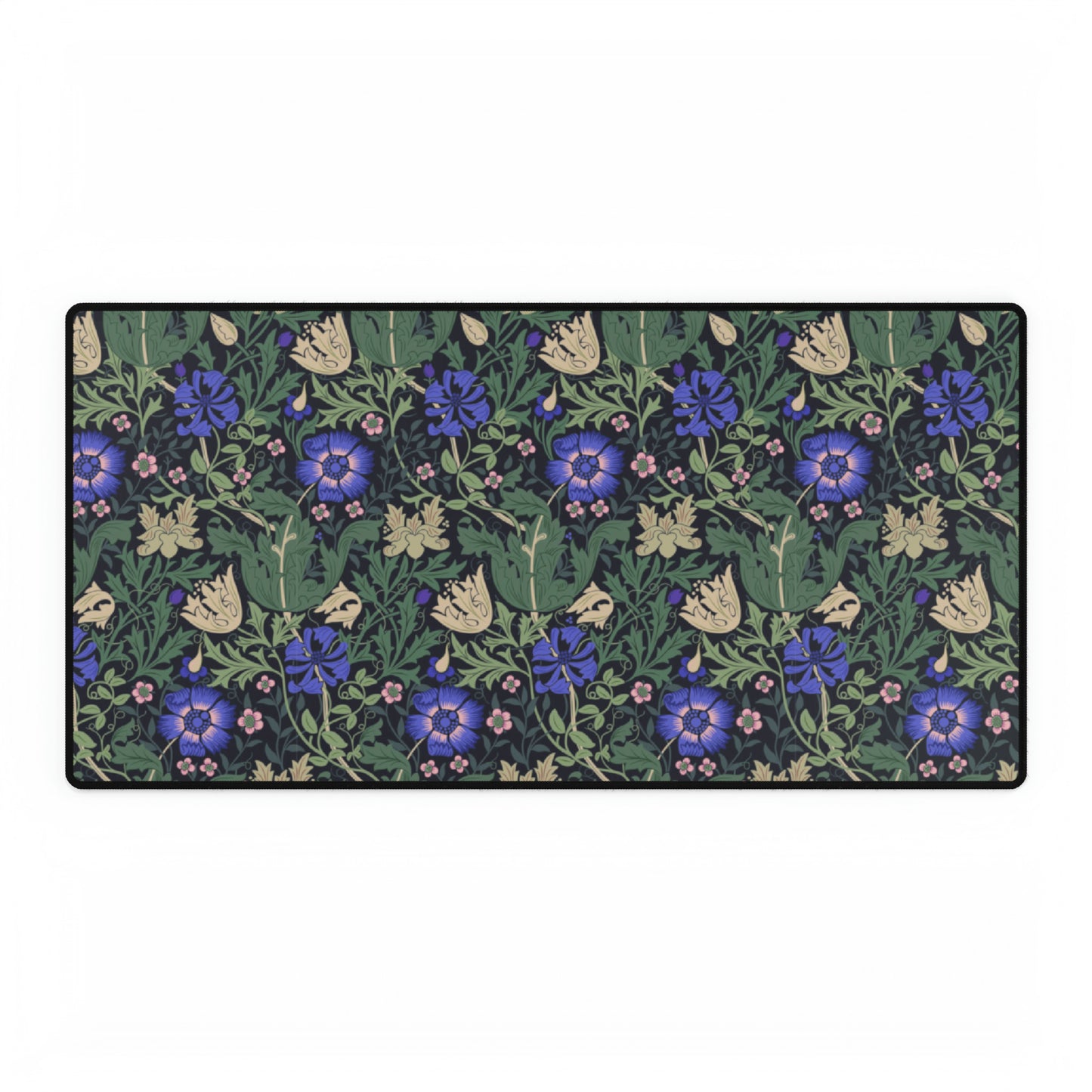 A desk mat with a William Morris & Co floral pattern, featuring a mouse pad on top. The desk mat has a non-slip base and is placed under a shelf with a computer monitor and a keyboard.