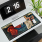 A desk mat with a floral and religious artwork design, accompanied by a computer keyboard and mouse on top of it, set against a white background.