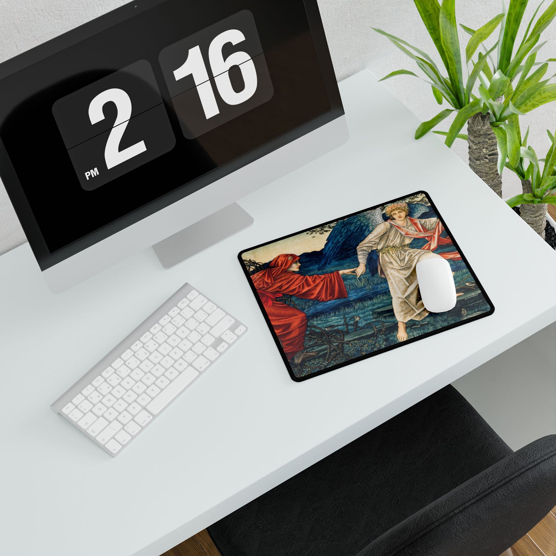 A desk mat with a floral and religious artwork design, accompanied by a computer keyboard and mouse on top of it, set against a white background.