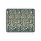 A large desk mat with a floral William Morris & Co pattern in evergreen teal colours, displayed on a desk with a keyboard and mouse.