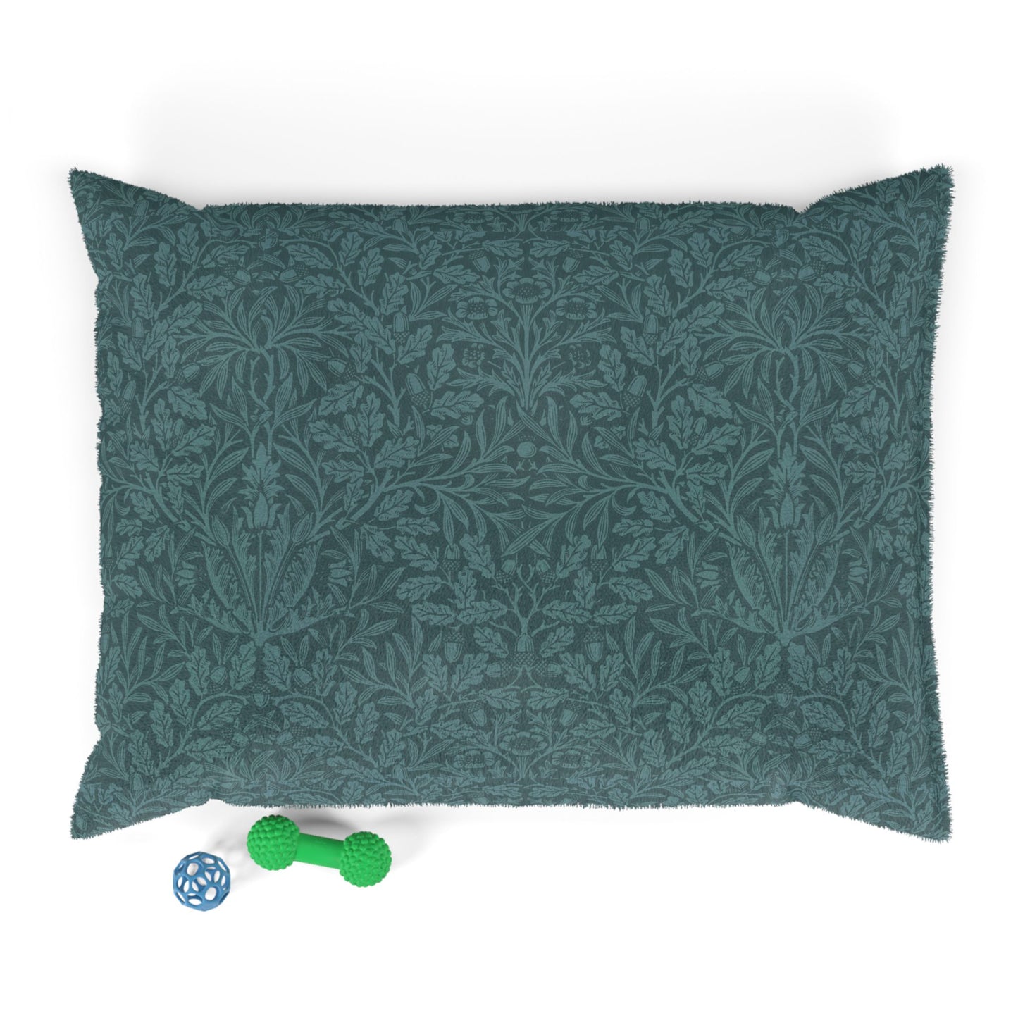 Green patterned pillow with a green dog toy on a white background