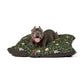 Dog lying on a William Morris & Co floral-patterned dog bed with a white background