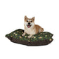 Dog sitting on a William Morris & Co floral-patterned dog bed with a white background