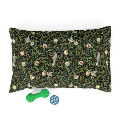 Decorative pillow with nature-themed pattern and two toys on a white background