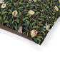 Decorative fabric with nature-themed pattern featuring leaves, fruits, and birds on a black background.