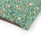 Fabric with a nature-themed William Morris & Co design featuring birds, leaves, and flowers on a teal background.