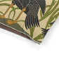 Close-up of a decorative fabric with bird and leaf pattern on a beige background