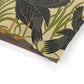 Close-up of a decorative paper with bird and plant pattern on a beige background