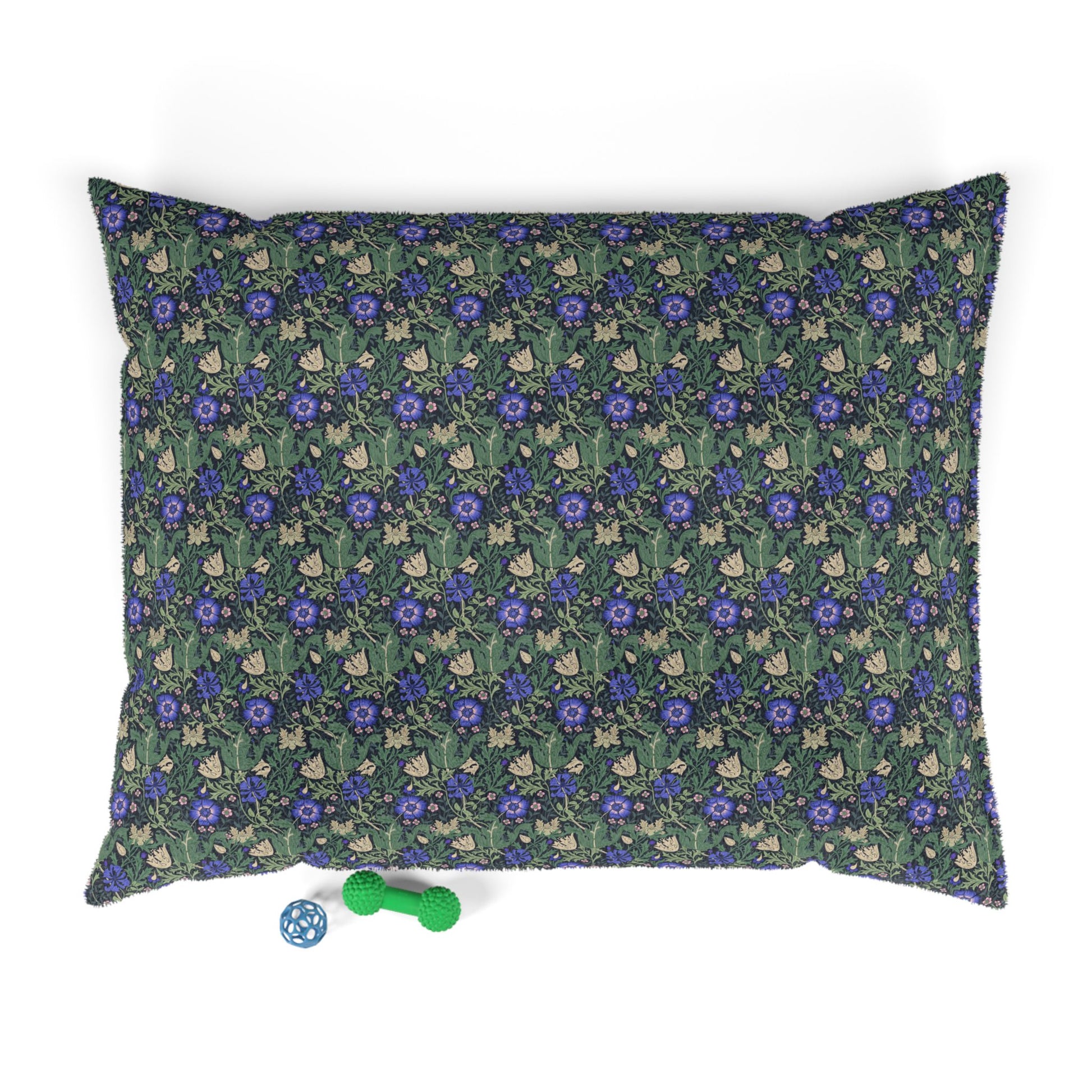 Floral patterned pet bed with dice and toy on a white background