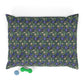 Floral-patterned pillow with a green dog toy on a white background
