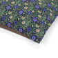 Floral patterned fabric with blue and purple flowers on a green background