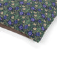 Floral patterned fabric with blue flowers on a green background