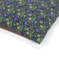 Floral patterned fabric with blue flowers on a green background