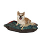 Dog sitting on a decorative dog bed with a white background