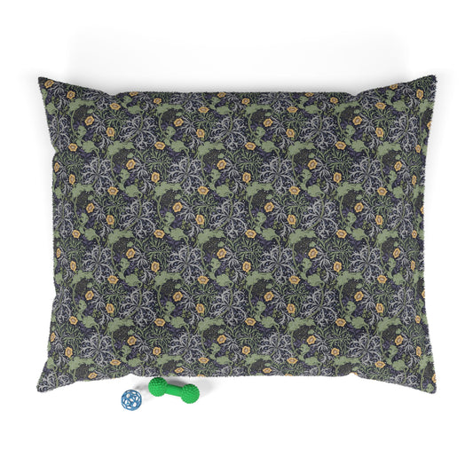 Floral patterned pet bed with a blue and green toy on a white background