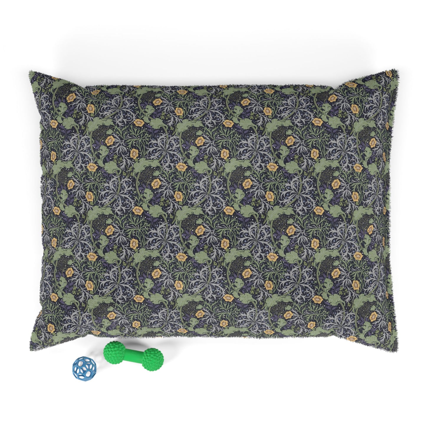 Floral patterned pet bed with a green bone-shaped toy on a white background