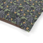 Patterned fabric with green, purple, and yellow design on a white background