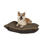 Dog sitting on a floral-patterned dog bed with a white background