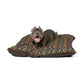 Dog lying on a patterned dog bed with a white background