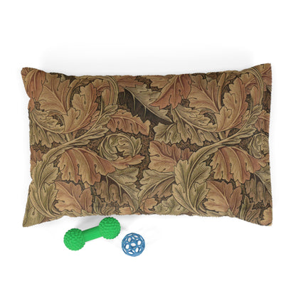 Decorative dog pillow with William Morris & Co leaf pattern and two dog toys on a white background
