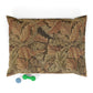 Decorative dog pillow with William Morris & Co leaf pattern and two small toys on a white background
