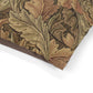 Close-up of a fabric with intricate William Morris & Co leaf pattern on a white background