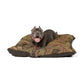 Dog lying on a decorative dog bed with a white background