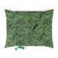 Green leaf-patterned pillow with two small toys on a white background