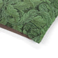 Green leafy patterned paper with a brown border on a white background