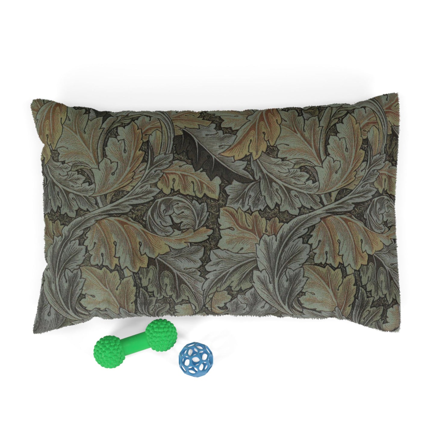 Decorative pillow with leaf pattern and two pet toys on a white background