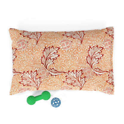 Floral patterned pillow with two dog toys on a white background