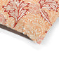 Close-up of a fabric with red and orange floral pattern on a white background