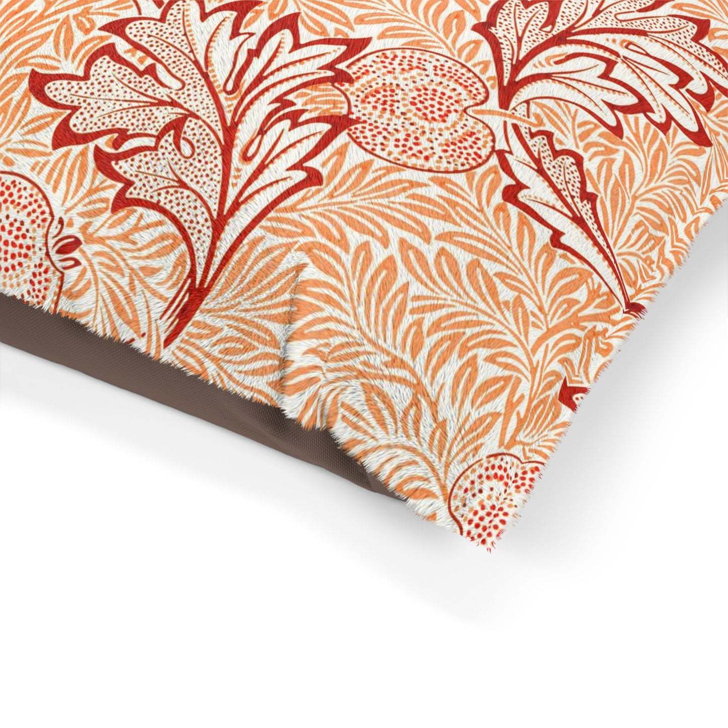 Close-up of a fabric with red and orange floral pattern on a white background