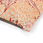 Close-up of a decorative paper with red and orange floral pattern on a white background