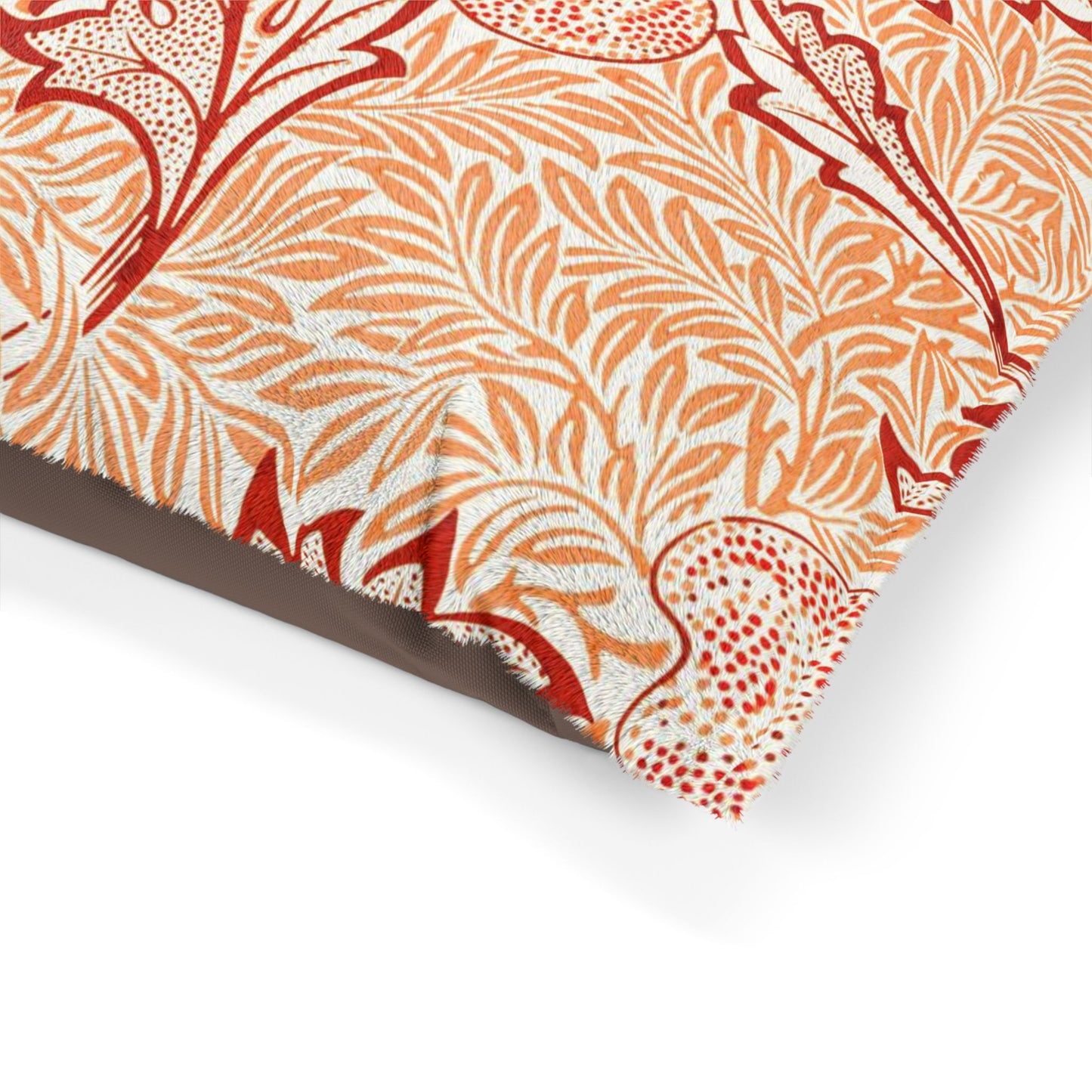 Close-up of a decorative paper with red and orange floral pattern on a white background